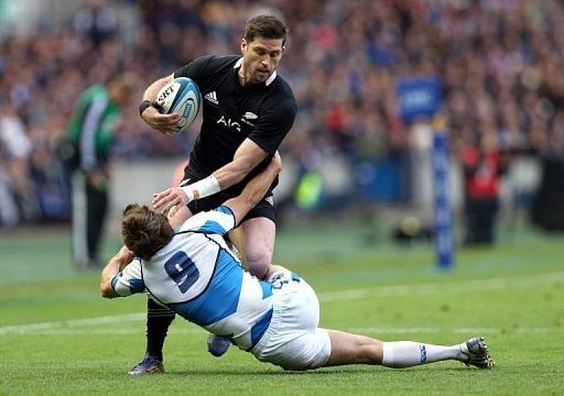 New Zealand&#039;s Cory Janes (back) is tackled by Scotland&#039;s Mike Blair