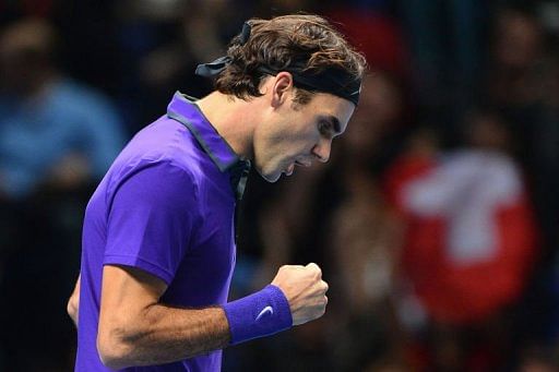 Roger Federer celebrates breaking the serve of Andy Murray