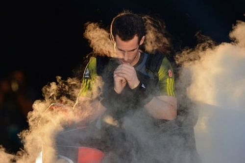 Andy Murray blows into his hands as he enters the court for his semi-final singles match