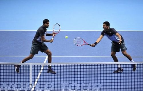 India's Rohan Bopanna (L) hits a return as his partner India's Mahesh Bhupathi (R) covers