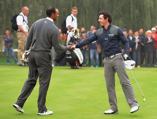 Tiger Woods of the US (L) shakes hands with Rory McIlroy of Northern Ireland in October