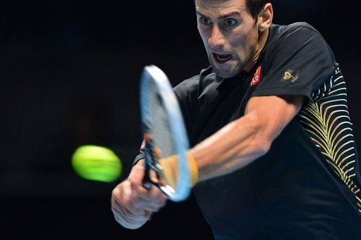 Serbia&#039;s Novak Djokovic returns against Switzerland&#039;s Roger Federer