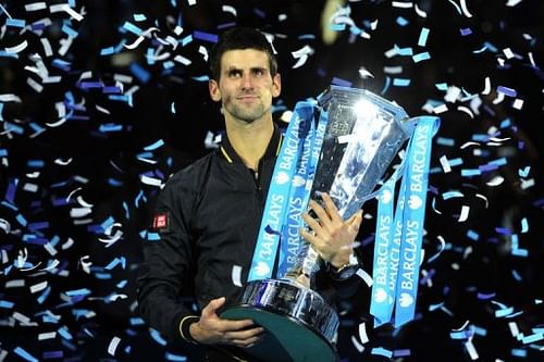 Novak Djokovic poses with the winners' trophy