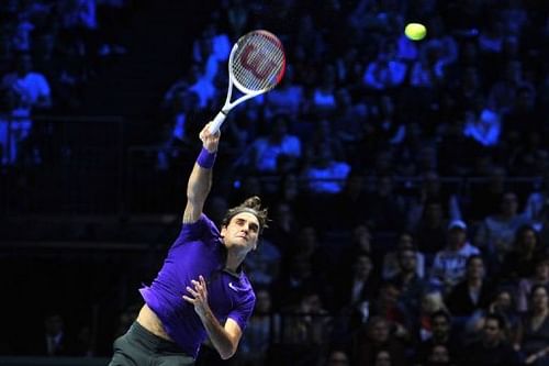 Roger Federer serves against Novak Djokovic