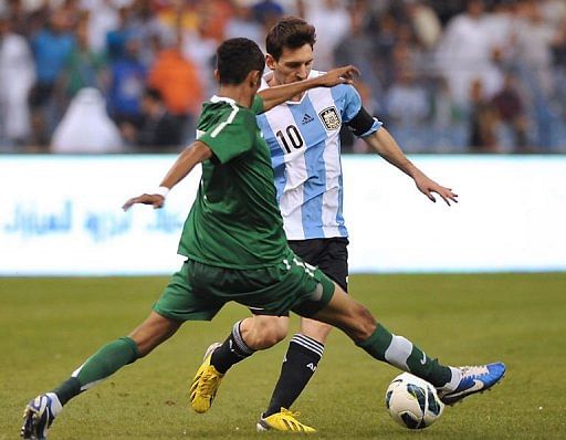 Saudi Arabia&#039;s Salman al-Faraj challenges Argentina&#039;s forward Lionel Messi (back)
