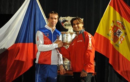 Radek Stepanek (left) shakes hand with David Ferrer after the Davis Cup final draw ceremony in Prague