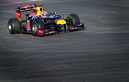 Sebastian Vettel of Red Bull Racing enters turn 1 during the first practice session
