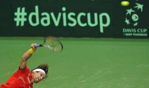 David Ferrer of Spain serves a ball