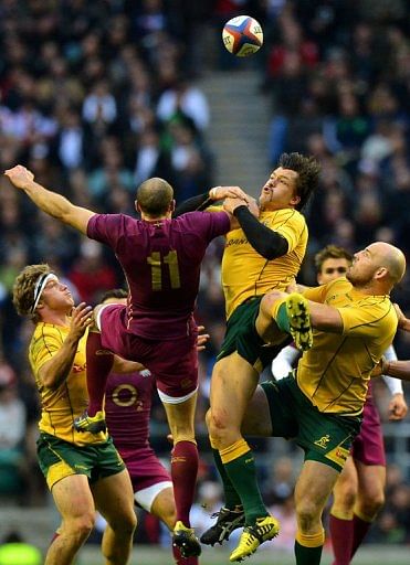 England wing Charlie Sharples (2nd L) jumps for the ball against Australia centre Adam Ashley-Cooper (2nd R)