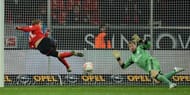 Leverkusen's striker Stefan Kiessling (L) scores past Schalke's goalkeeper Lars Unnerstall