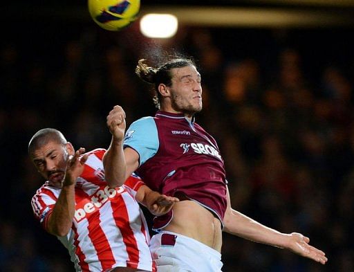 West Ham&#039;s Andy Carroll (R) jumps for the ball against Stoke&#039;s Jon Walters