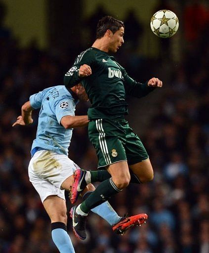 Manchester City&#039;s Pablo Zabaleta (L) jumps with Real Madrid&#039;s Cristiano Ronaldo