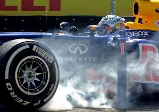German Formula One driver Sebastian Vettel blocks the wheels of his RedBull during free practice at Interlagos