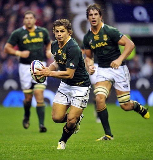 South Africa&#039;s fly-half Pat Lambie runs with the ball during the rugby union Test match against England at Twickenham