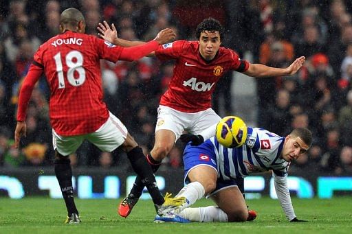 Manchester United&#039;s Brazilian defender Rafael (C) and English forward Ashley Young (L) challenge QPR&#039;s Adel Taarabt