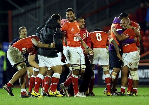 Tongan players celebrate victory during the International rugby union test match between Scotland and Tonga