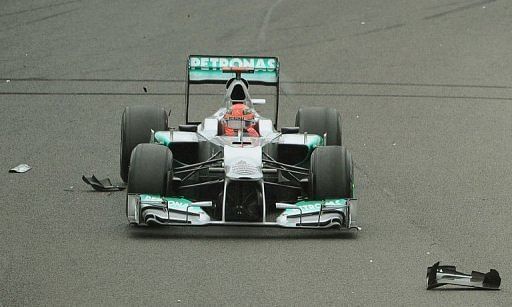 Michael Schumacher passes over debris from Mark Webber&#039;s car