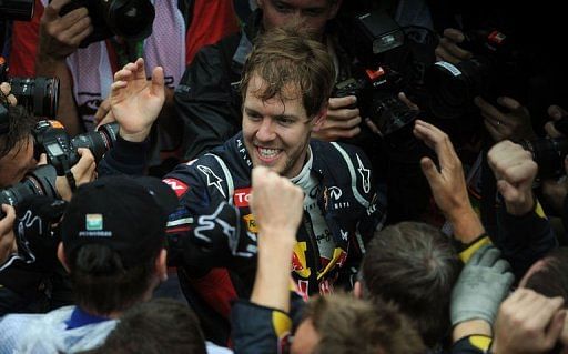 Sebastian Vettel celebrates with the Red Bull team