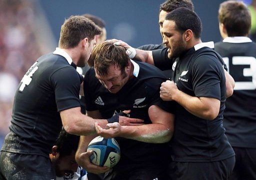 New Zealand players congratulate teammate Andrew Hore (C) on November 11