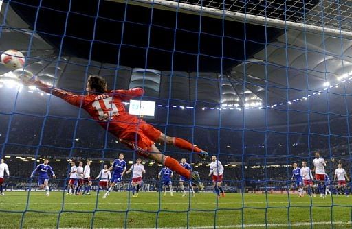 Hamburg&#039;s goalkeeper Rene Adler saves a free-kick against Schalke 04 on November 27