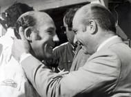 Sport Motor Racing. pic: 22nd August 1968. Nuerburgring, Germany. Famous Argentine former world champion racing driver Juan Fangio has a friendly greeting for British ace Stirling Moss, left.