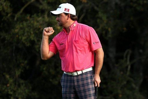 Graeme McDowell of Northern Ireland pumps his fist after making a birdie putt on the 18th hole