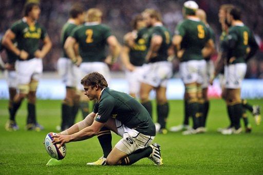 S. Africa&#039;s fly-half Pat Lambie prepares the ball before kicking a penalty at a match against England in November 2012