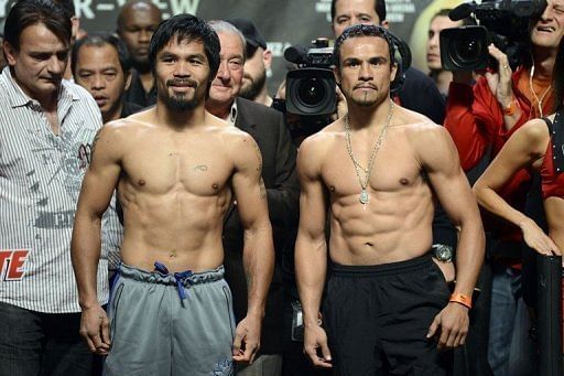 Manny Pacquiao (L) and Juan Manuel Marquez pose during the official weigh-in