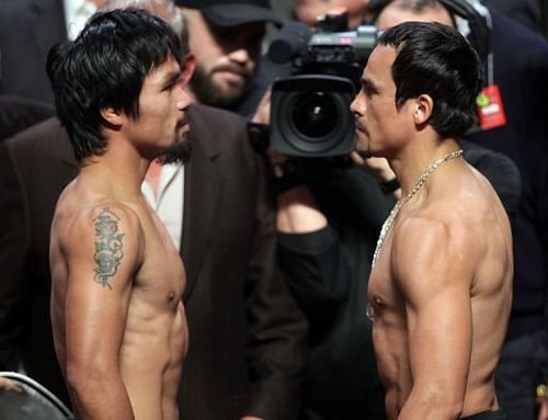 Manny Pacquiao (L) of the Philippines faces Juan Manuel Marquez (R) of Mexico during their weigh-in