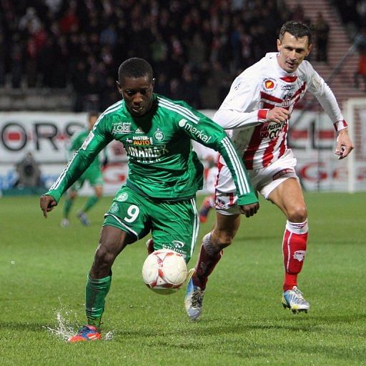 Saint-Etienne&#039;s Max Alain Gradel (L) fights for the ball with Ajaccio&#039;s Yohan Poulard