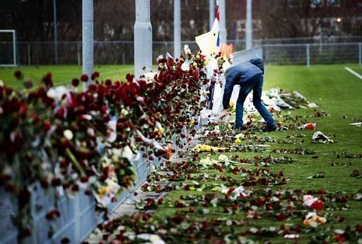 A man places flowers at linesman Richard Nieuwenhuizen&#039;s memorial site in Almere, Netherlands, on December 10, 2012