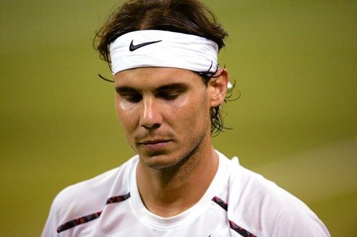 Rafael Nadal trudges off court after losing his second round match against Lukas Rosol at Wimbledon on June 28, 2012