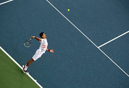 World number one Novak Djokovic serves the ball to Andy Murray during their ATP Dubai Open semi-final on March 2, 2012