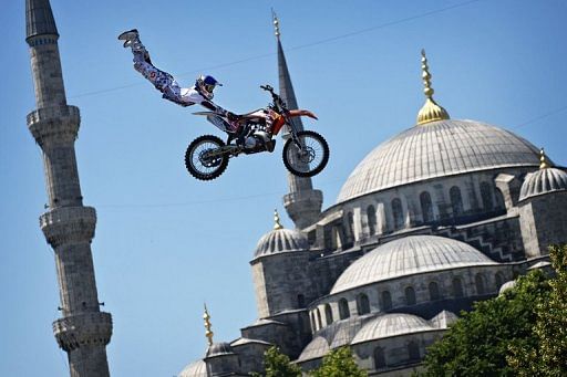 A biker performs a demo jump in front of the Blue Mosque in Istanbul on June 13, 2012