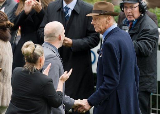 Racehorse trainer Henry Cecil (R) after his horse Frankel won the Champion Stakes at Ascot on October 20, 2012