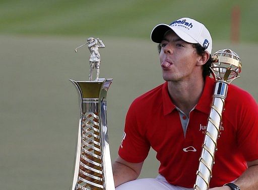 Rory McIlroy poses with his trophy after winning the DP World Tour Championship in Dubai on November 25, 2012