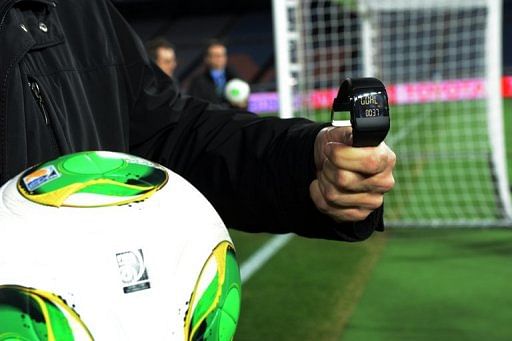 A FIFA official displays new goal-line technology for the press in Yokohama on December 5, 2012