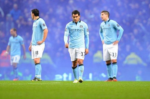 Manchester City&#039;s Carlos Tevez (centre) Gareth Barry (left) and Matija Nastasic (right), Manchester on December 9, 2012