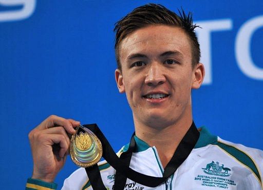 Robert Hurley of Australia smiles on the podium after winning the men&#039;s 50m backstroke final