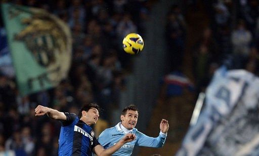 Lazio&#039;s forward Miroslav Klose (R) jumps for the ball with Inter Milan&#039;s defender Andrea Ranocchia on December 15, 2012