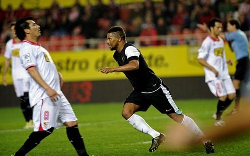 Malaga&#039;s midfielder Eliseu (C) celebrates after scoring a goal in Sevilla on December 15, 2012