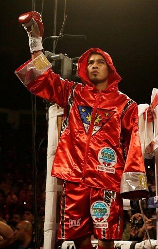 Nonito Donaire waves to the crowd before his WBO super bantamweight title bout vs Jorge Arce, on December 15, 2012