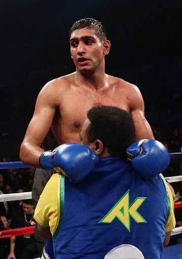 Amir Khan celebrates his victory over Carlos Molina, on December 15, 2012
