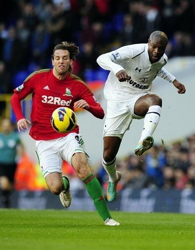 Tottenham defender William Gallas clears the ball from Swansea forward Michu at White Hart Lane on December 16, 2012