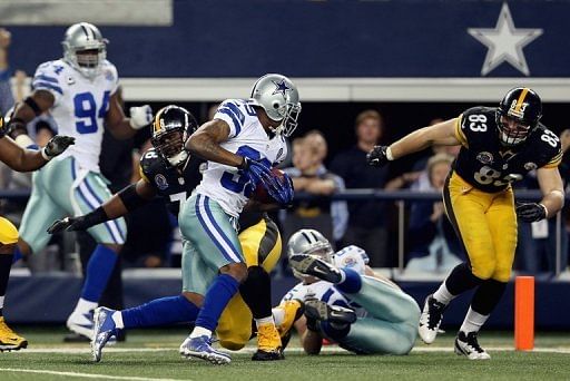 Brandon Carr of the Dallas Cowboys runs after making an interception against the Pittsburgh Steelers on December 16, 2012