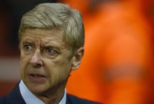 Arsenal's French manager Arsene Wenger takes his seat before a UEFA Champions League match on November 21, 2012 Arsenal's French manager Arsene Wenger takes his seat before a UEFA Champions League match on November 21, 2012