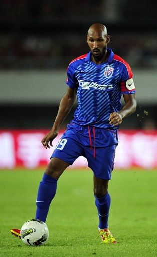 Nicolas Anelka dribbles the ball against Guangzhou Evergrande in a Chinese Super League match on July 28, 2012