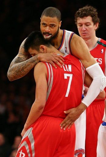 Tyson Chandler of the New York Knicks embraces former teammate Jeremy Lin of the Houston Rockets on December 17, 2012