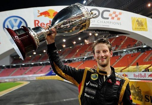 French F1 driver Romain Grosjean celebrates with the trophy after winning the Race of Champions on December 16, 2012