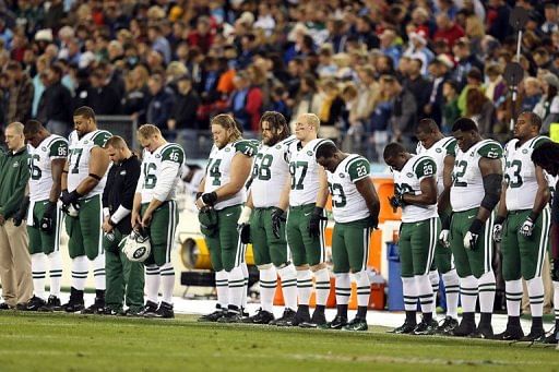 The New York Jets stand on the sideline in a moment of silence on December 17, 2012 for the victims of the mass shooting